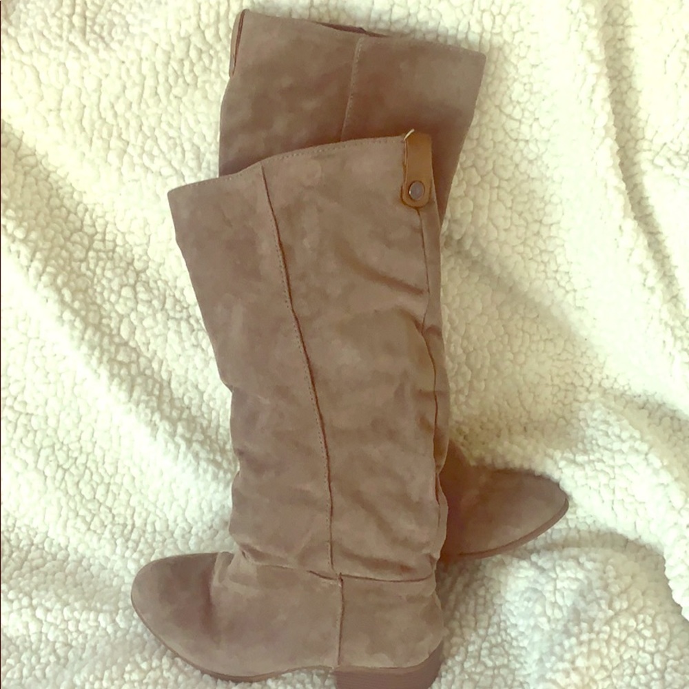 Knee high brown suede boots.